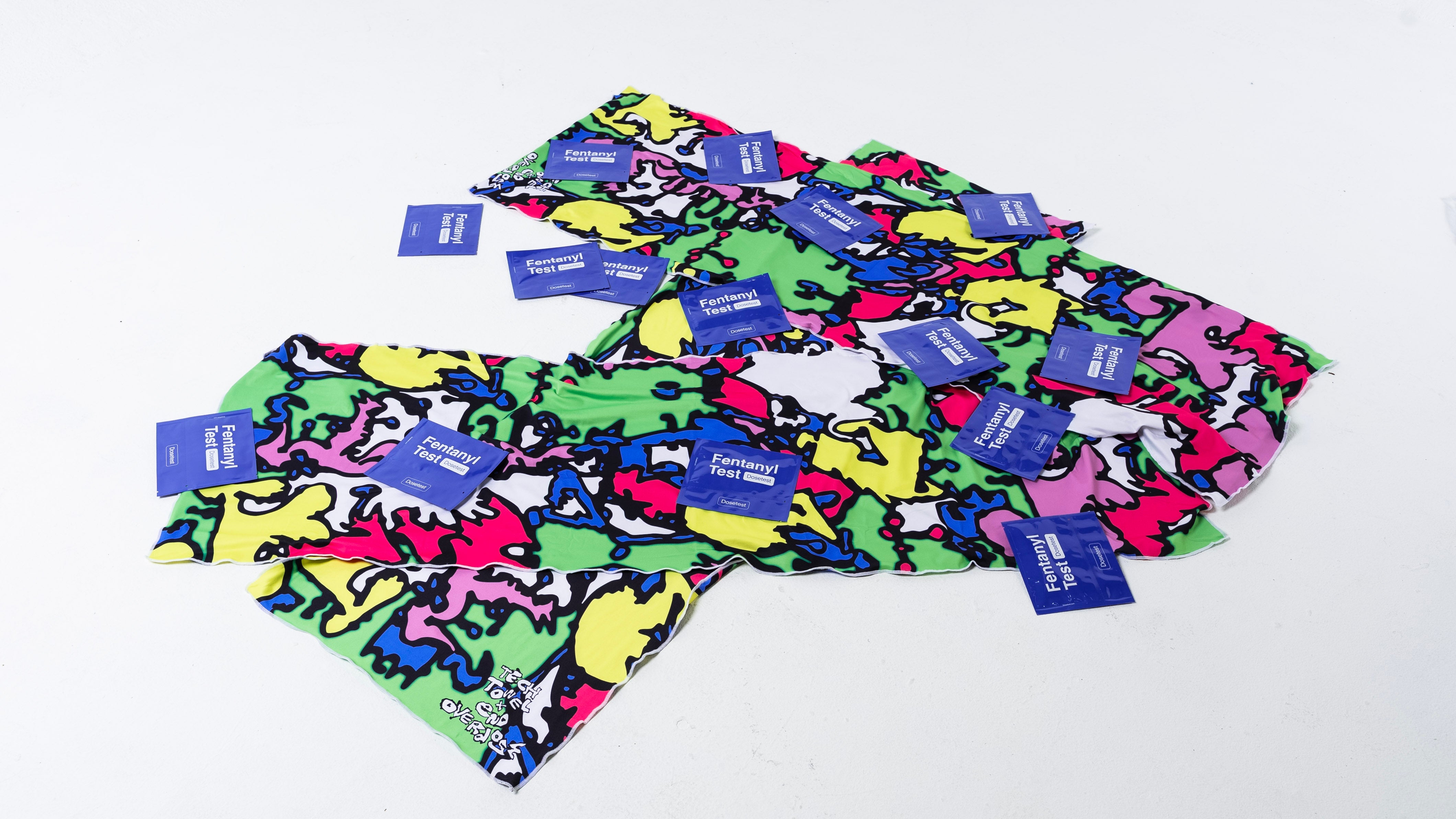 Tech Towel laid out with fentanyl test strips to show festival utility and harm reduction
